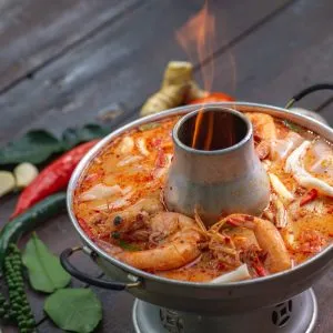 Tom Yum Kung, a known Thai dish with hot spicy soup with prawn, lemongrass, lemon, galangal, mushrooms, chilli, and coconut milk