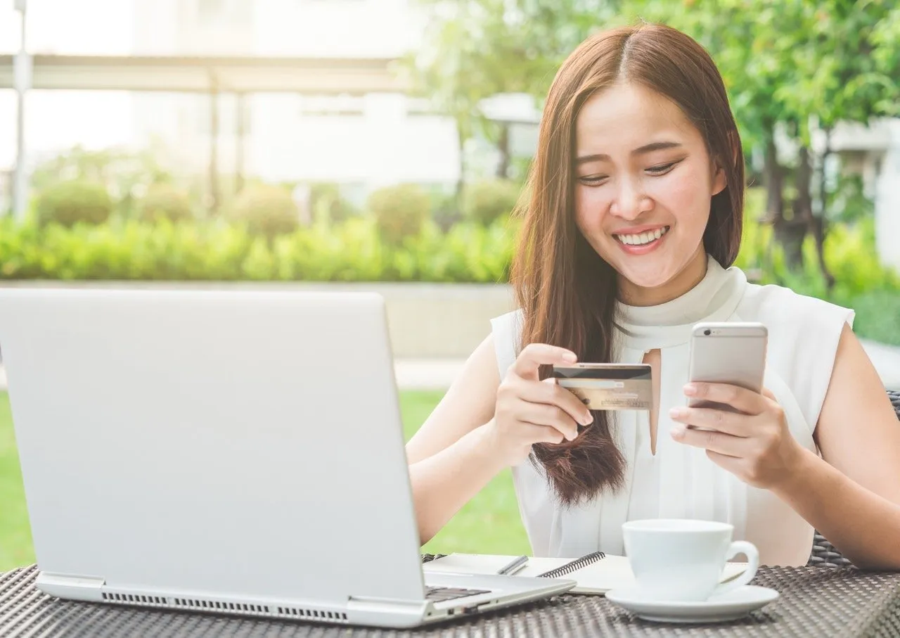 A young lady using a credit card for online shopping