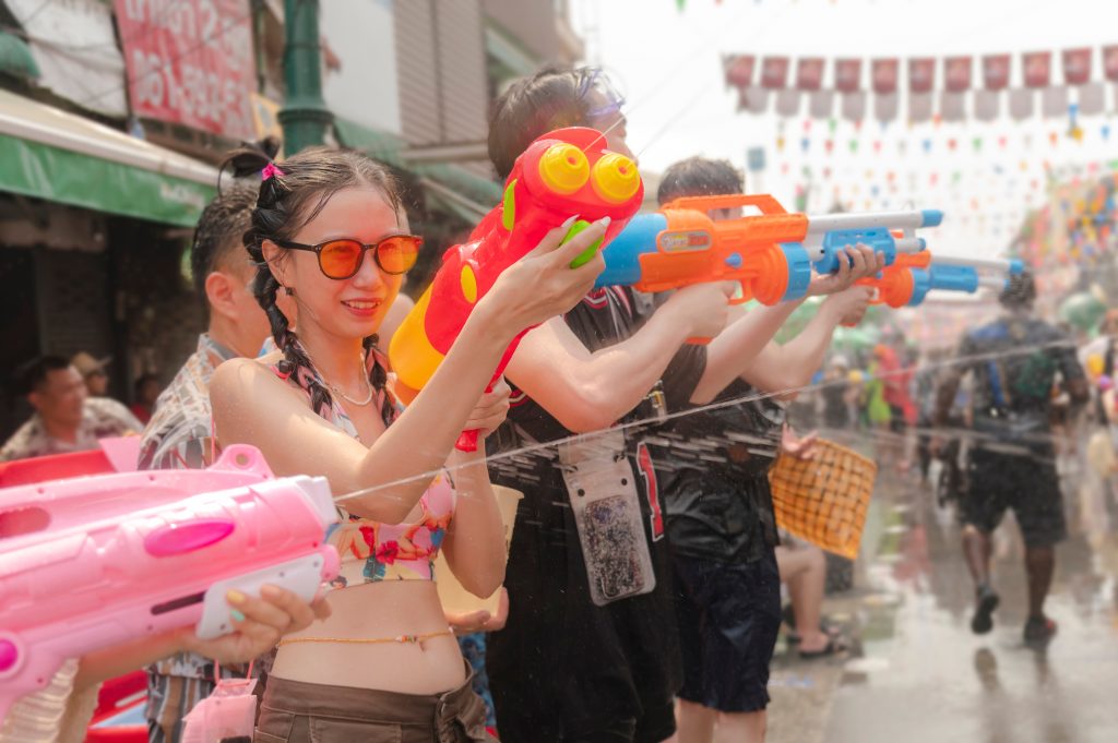 Thai people using water guns during the Songkran Festival in Bangkok Thailand =