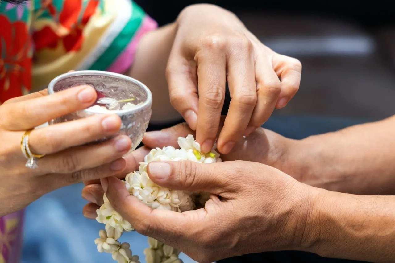 Pouring scented water over elders' and elderly family members' hands and ask for their blessing on Songkran day
