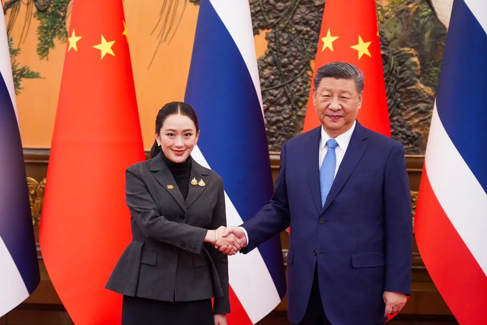 Prime Minister Paetongtarn Shinawatra (left) shaking hands with Xi Jinping, President of the People’s Republic of China