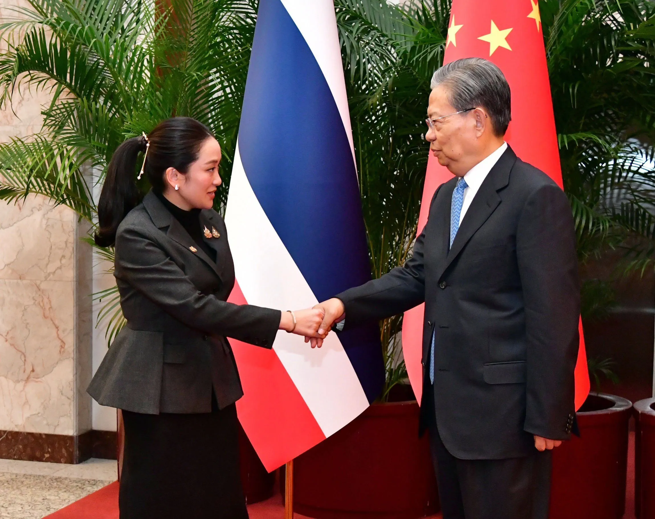 Prime Minister Paetongtarn Shinawatra shaking hands with Zhao Leji, Chairman of the Standing Committee of the National People's Congress of the Peoples Republic of China