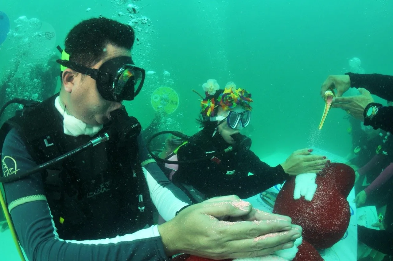 Bride and groom in underwater wedding ceremony at Koh Kradan island in Trang Thailand