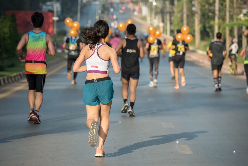 A young woman runner running in a marathon