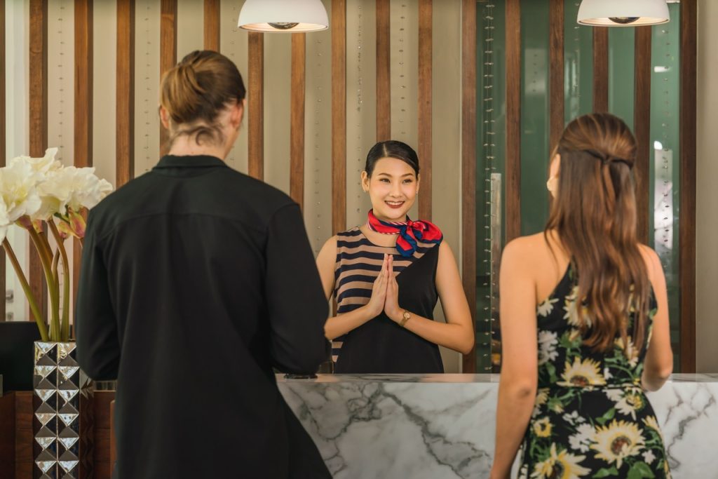 Thai hotel staff welcoming guests the Thai way