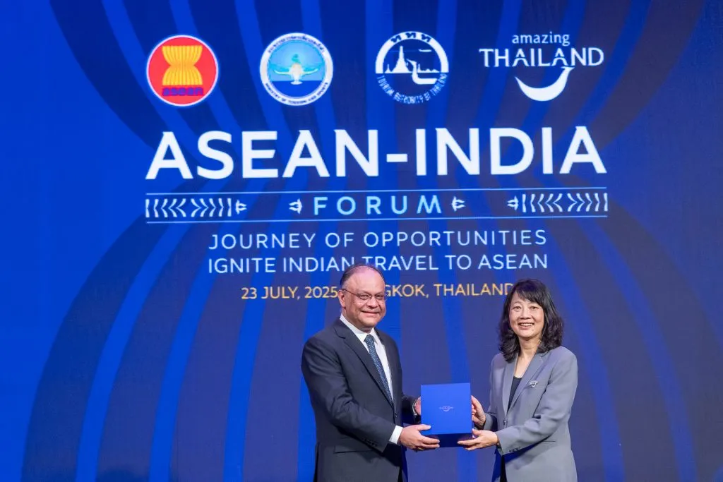 Ambassador of India to Thailand Nagesh Singh holding a commemorative plaque with TAT Deputy Governor Pattaraanong Na Chiangmai.