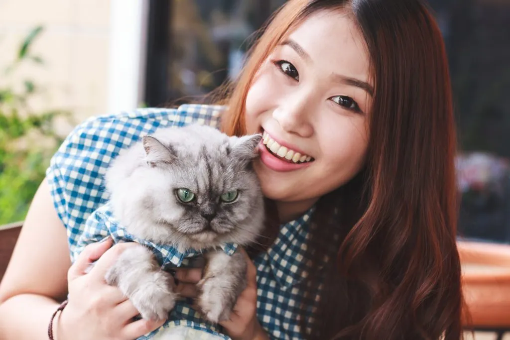 A woman and her cat in matching outfits.