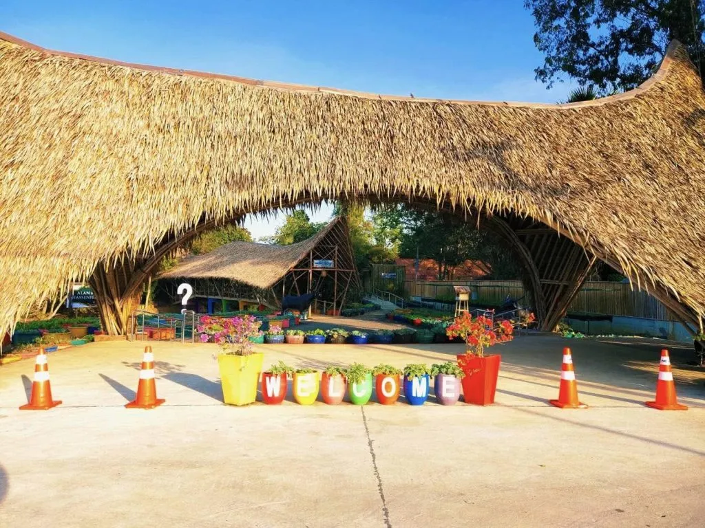 Welcome sign in front of the bamboo pavilion at Mechai Bamboo School.
