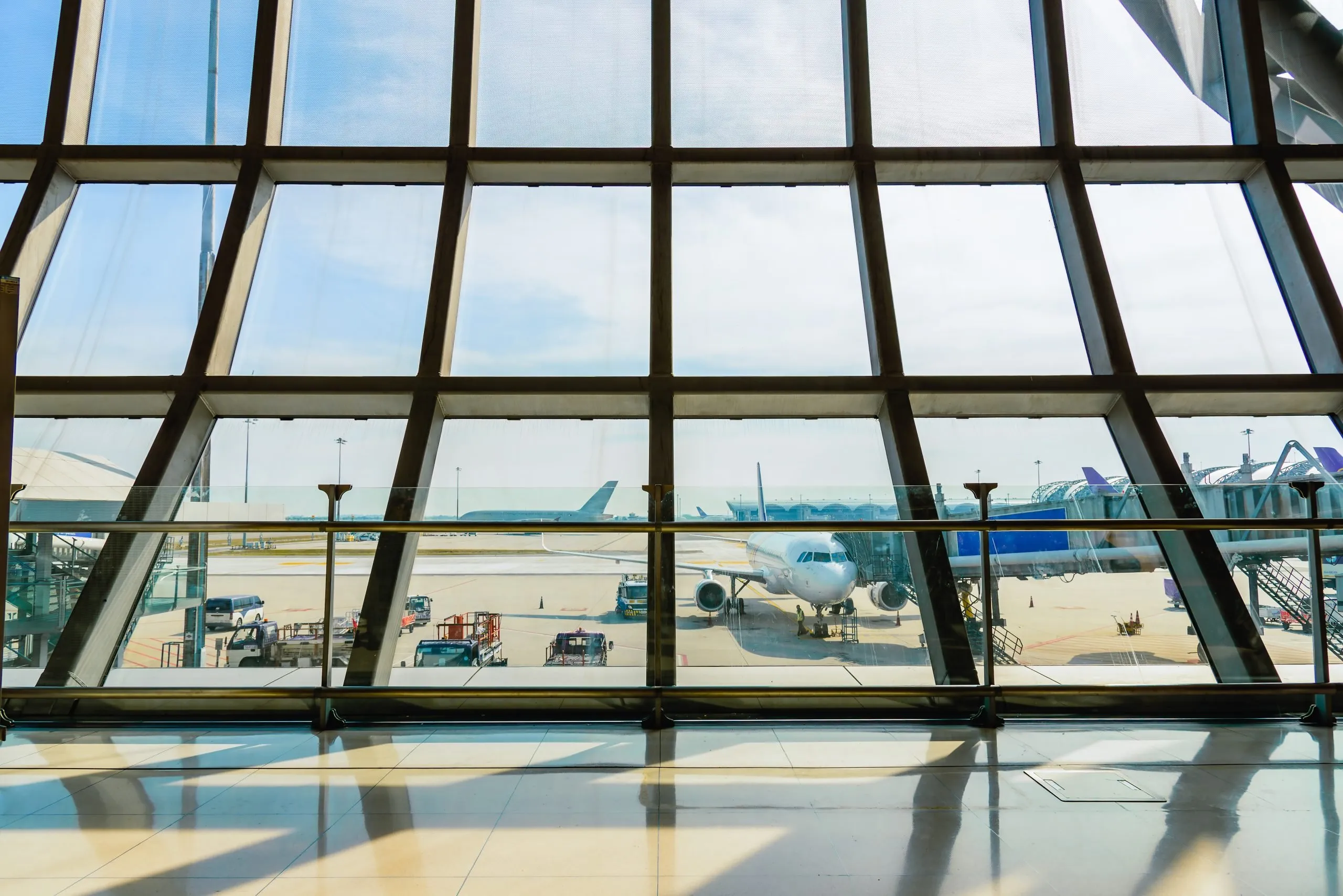 View through the glass windows at the departure terminal of Suvarnabhumi Airport.