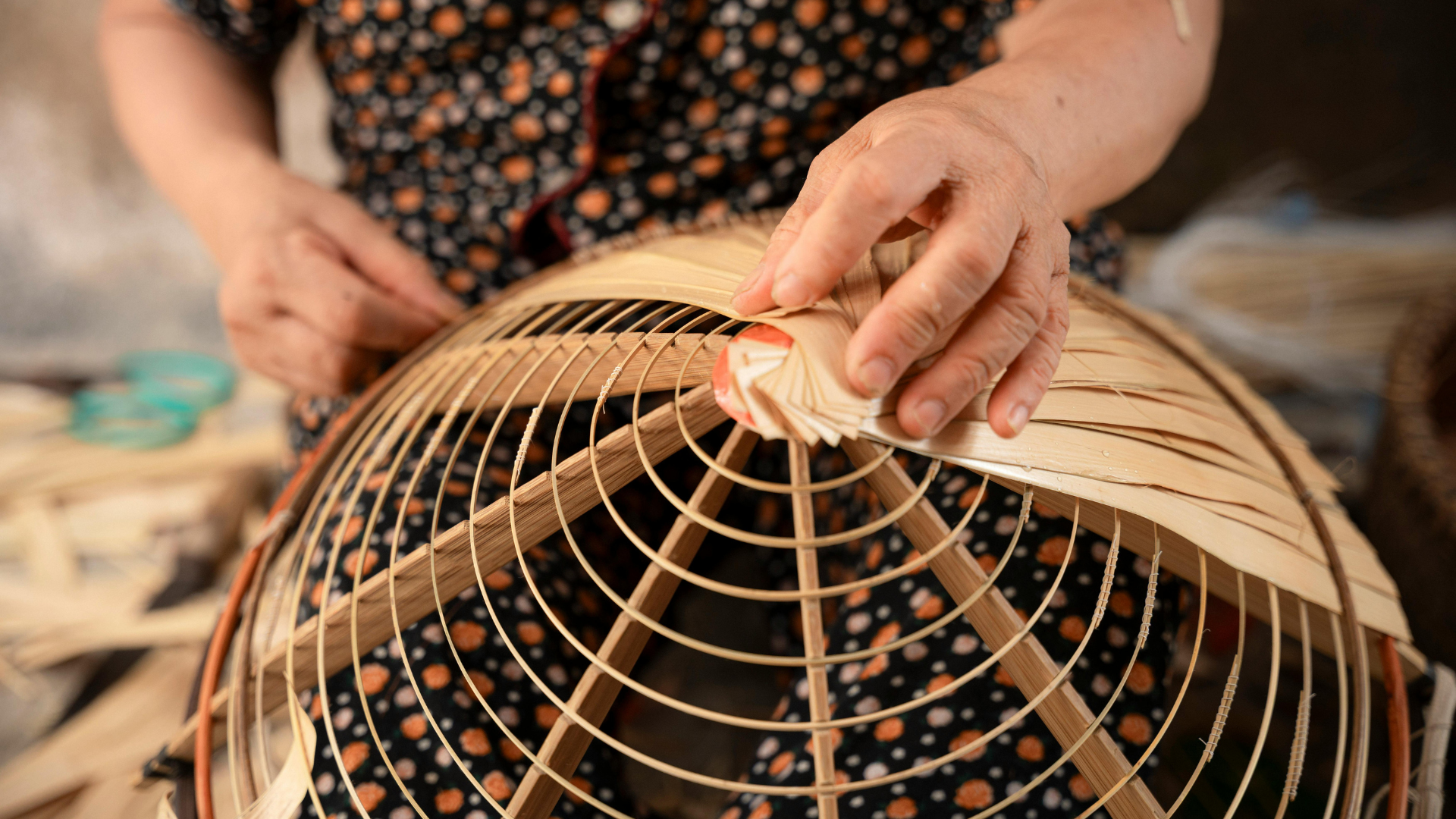 A Thai artisan at work, weaving a traditional basket