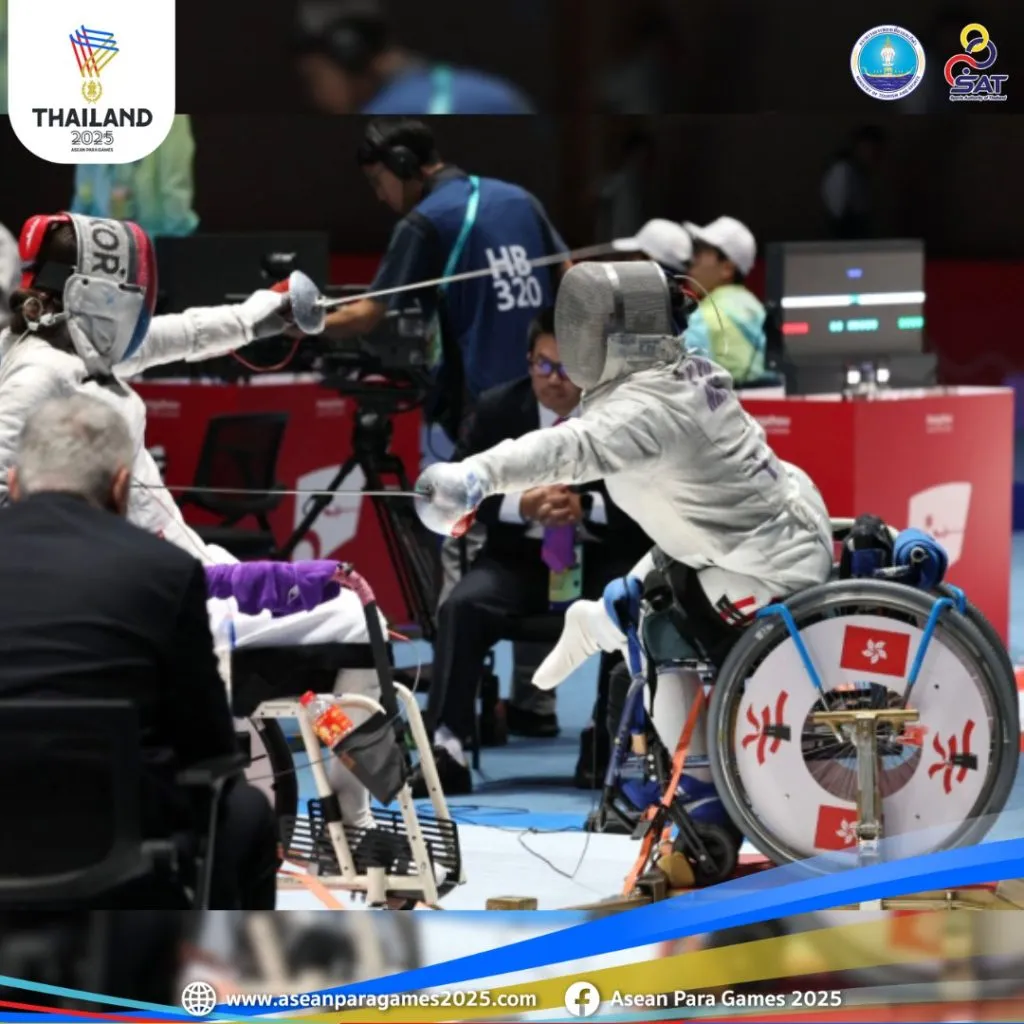 fencing athlete wearing full gear on wheelchair having at each other