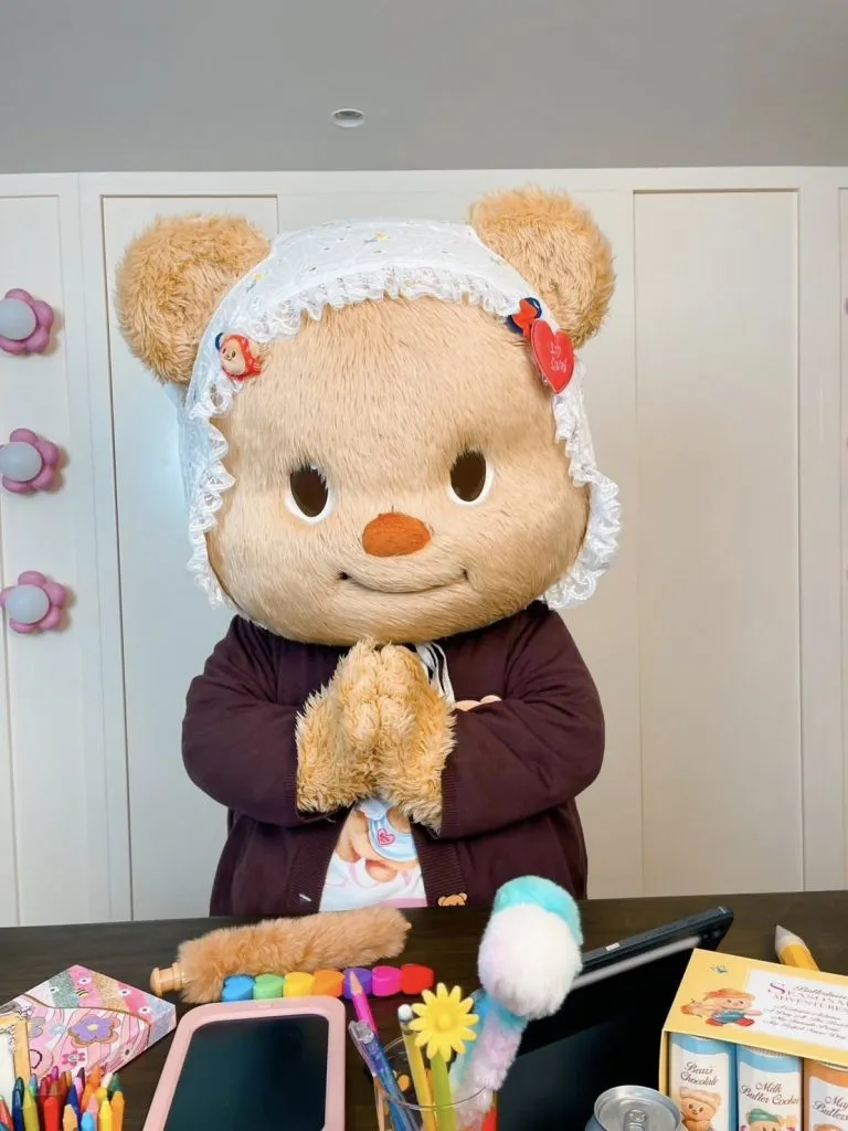 mascot butterbear does the sawaddee in a dressing room