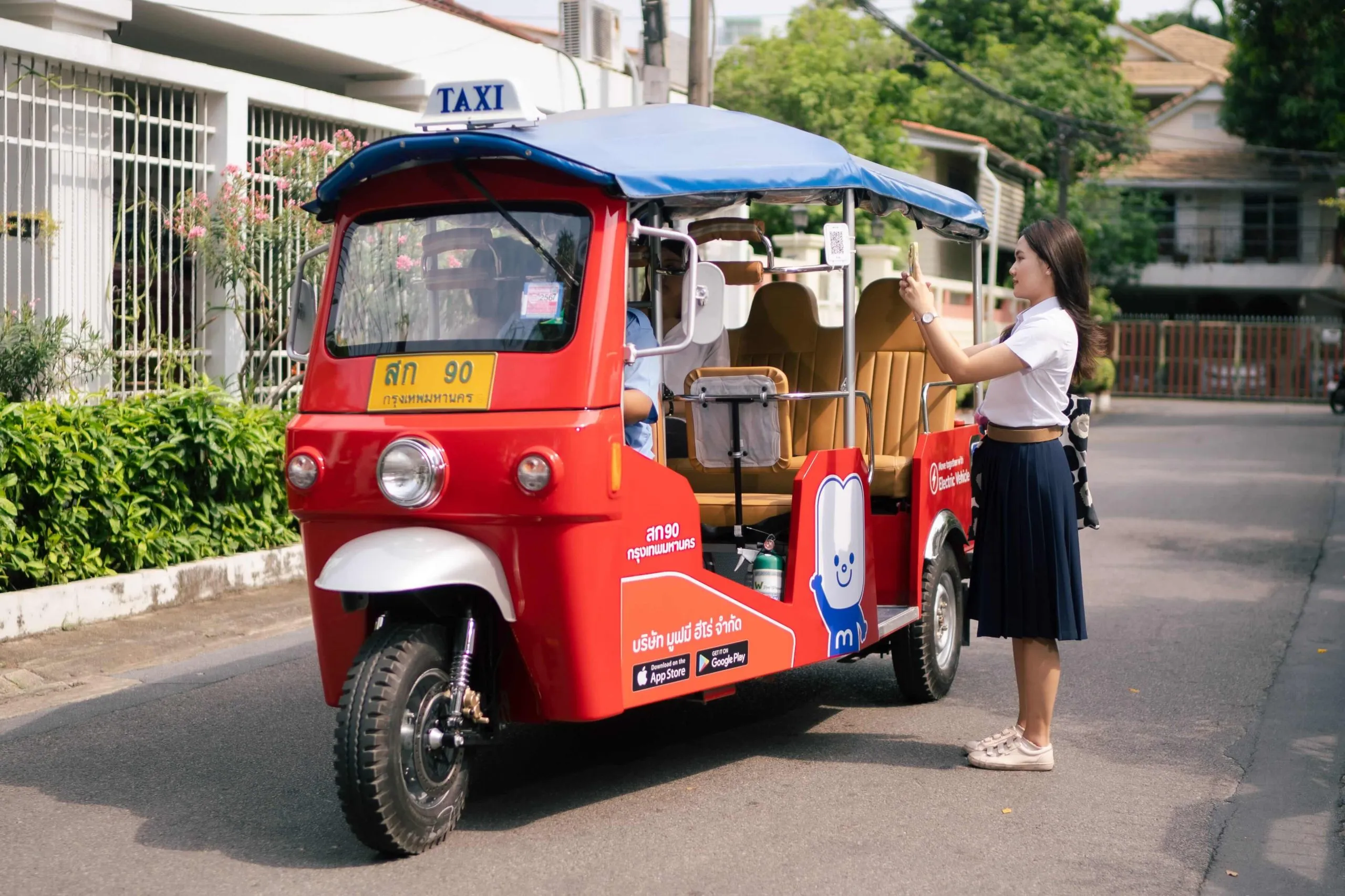 A university student getting into a MuvMi electric tuk-tuk