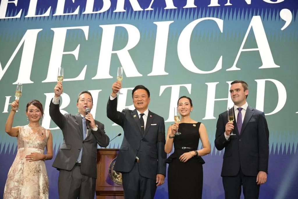 Five dignitaries, including Ambassador Sean O'Neill and Prime Minister Anutin Charnvirakul, raise champagne glasses for a toast.