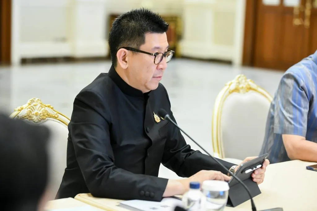 DPM Ekniti Nitithanprapas operates a tablet during a boardroom conference meeting.