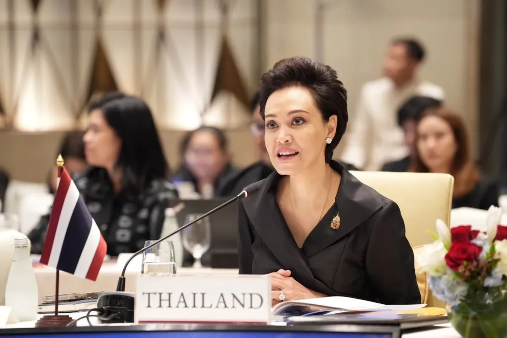 DPM and Commerce Minister Suphajee Suthumpun dressed in black sitting in a conference room with a label Thailand in front of her on a table.