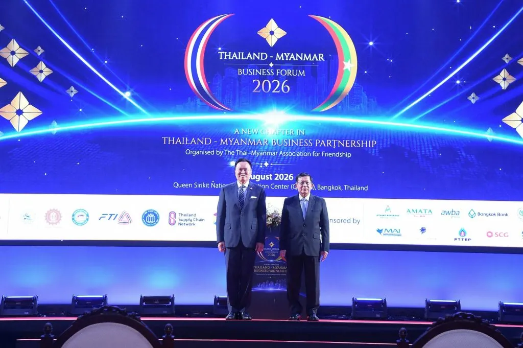 Thai Prime Minister Anutin Charnvirakul stands beside Myanmar leader Min Aung Hlaing on stage at a business forum.