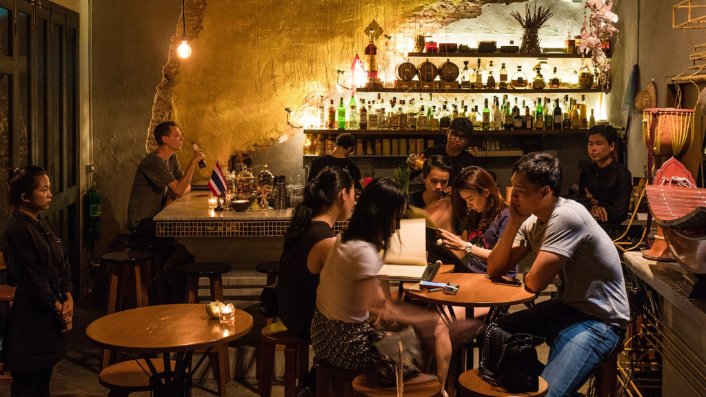 Guests gather inside TEP BAR, a Thai cultural bar in Bangkok.