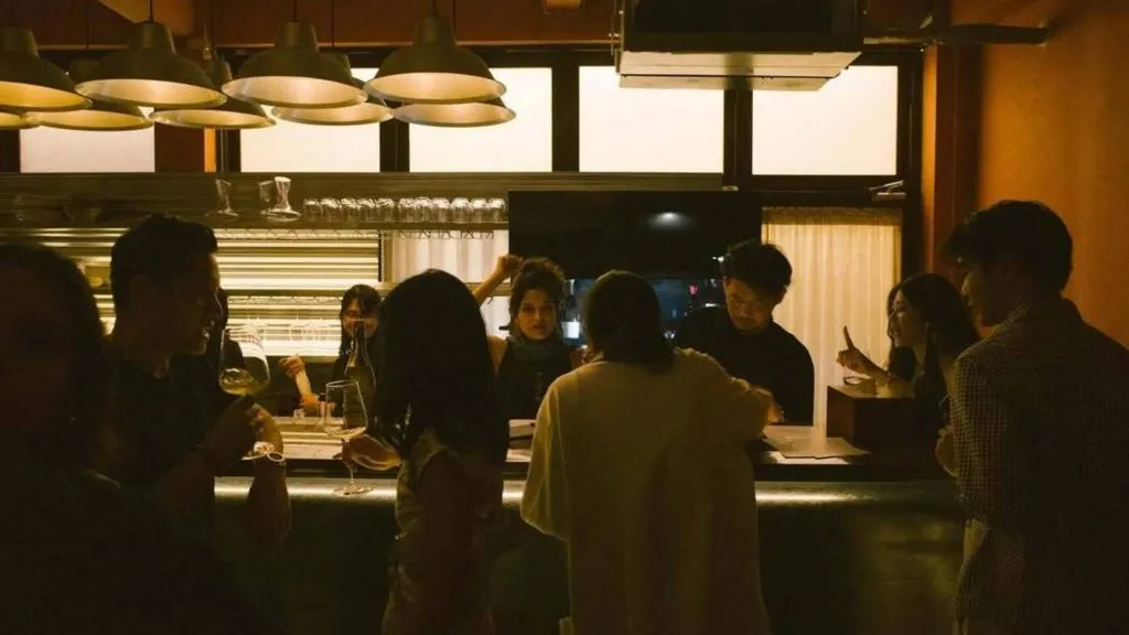 Guests gather around the bar at Sala Saneha in Bangkok’s Silom area.