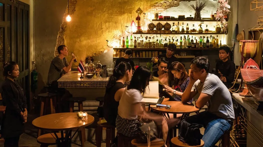 Guests gather inside TEP BAR, a Thai cultural bar in Bangkok.