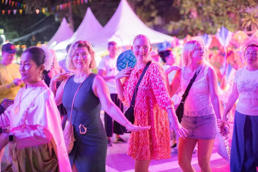 Five female enjoying themselves in a fairground.